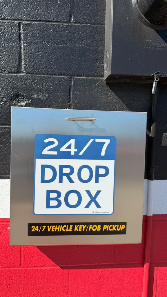 24/7 key drop box on the wall at First Class Auto Service